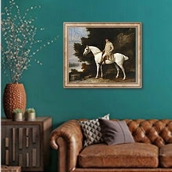 «A Gentleman on a Grey Horse in a Rocky Wooded Landscape, 1781» в интерьере гостиной с зеленой стеной над диваном